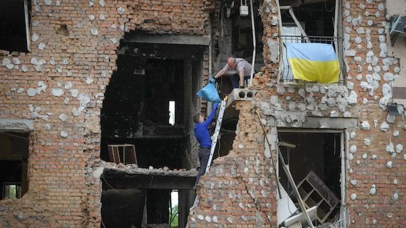 Ukraine, Kyiv Residents take out their belongings from their house ruined by the Russian shelling in Irpin close to Kyiv, Ukraine, Saturday, May 21, 2022. (AP Photo/Efrem Lukatsky)