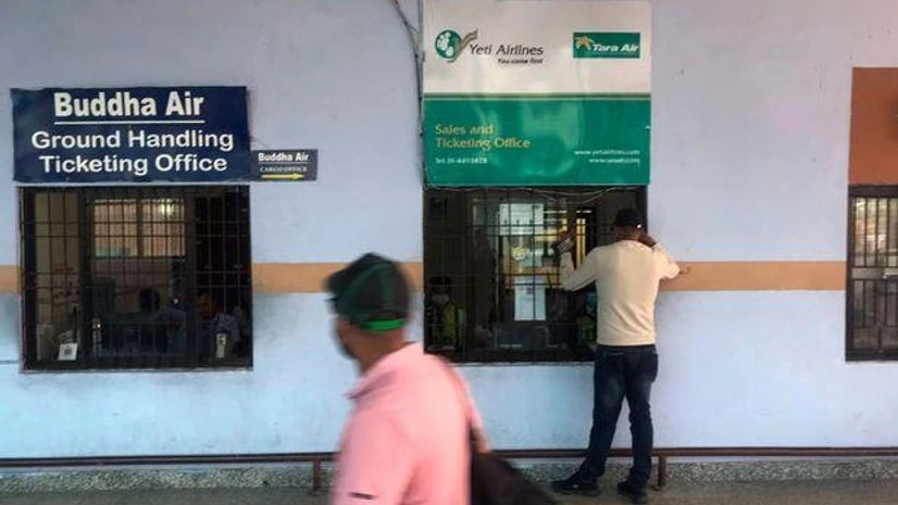 A man makes an enquiry outside a sales and ticketing office of Tara Airlines at the Tribhuvan International Airport in Kathmandu, Nepal, Sunday, May 29, 2022. A man makes an enquiry outside a sales and ticketing office of Tara Airlines at the Tribhuvan International Airport in Kathmandu, Nepal, Sunday, May 29, 2022.