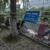 A sign and barrier tape placed to prevent large groups from gathering at an outdoor park in Beijing, on May 28. (Photo: Bloomberg)