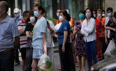 China eases covid curbs after protests, likely to scrap zero-Covid policy People line up for nucleic acid tests on a street, amid new lockdown measures in parts of the city to curb the coronavirus disease (COVID-19) outbreak in Shanghai, China, June 11, 2022. REUTERS/Aly Song