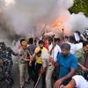 Security personnel use fire extinguishers to disperse Indian Youth Congress (IYC) members during their Mashal March against governments newly introduced Agnipath scheme, at Jantar Mantar in New Delhi