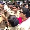 Senior Congress leader Renuka Chowdary holds a cop's collar during a protest over Congress leader Rahul Gandhis questioning by the Enforcement Directorate in connection with the National Herald case, in Hyderabad