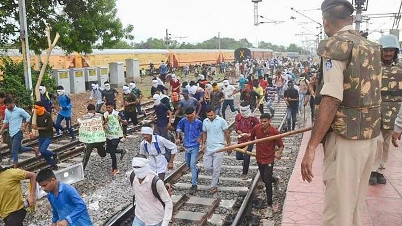 Agnipath protest Youngsters being chased away by police personnel during their protest against governments newly introduced Agnipath scheme, at Birlanagar Junction railway station, in Gwalior (Photo: PTI)