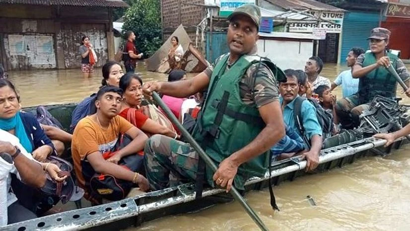 Assam floods Security personnel rescue people from a flood-affected area in Silchar (Photo: PTI)