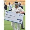 Mumbai's Sarfaraz Khan poses with his prize cheque after being named Man Of The Series, at a prize distribution ceremony following Madhya Pradesh's win in the final Ranji Trophy cricket match, at M Chinnaswamy Stadium, in Bengaluru (Photo: PTI)
