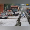 Vehicles wade through a waterlogged service road of the Delhi- Gurugram Expressway after heavy monsoon rains, in Gurugram (Photo: PTI)