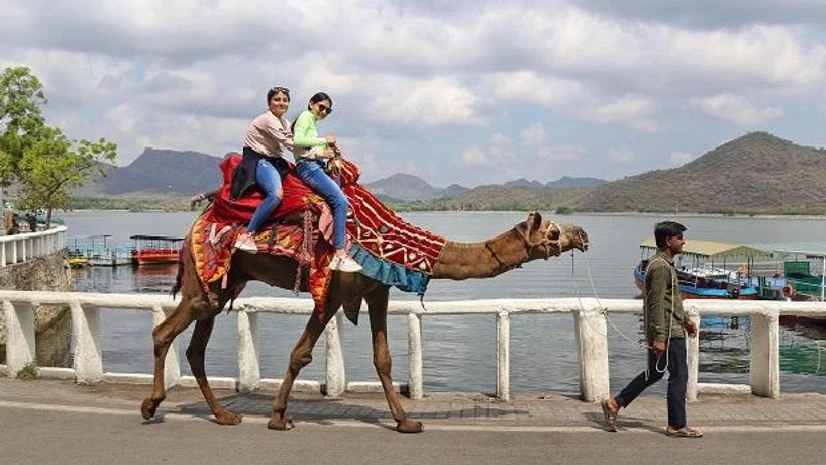 Tourists ride a camel, in Udaipur (Photo: PTI) Tourists ride a camel, in Udaipur (Photo: PTI)