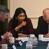 British Minister for Brexit Opportunities and Government Efficiency Jacob Rees-Mogg, British Attorney General Suella Braverman and British Parliamentary Secretary to the Treasury Chris Heaton-Harris share a laugh during a cabinet meeting in Downing S