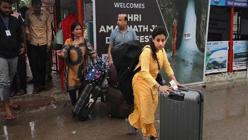 Amarnath pilgrims Amarnath pilgrims leave Bhagwati Nagar base camp as they return back home, in the wake of recent cloudburst near the holy cave shrine, in Jammu (Photo: PTI)