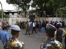 Sri Lanka Government soldiers, police officers and supporters gather outside the burnt private residence of prime minister Ranil Wickremesinghe in Colombo (Photo: AP/PTI)