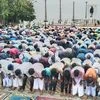 Muslim devotees offer prayers on the occasion of Eid al-Adha, near the statue of Mahatma Gandhi at Puducherry beach (Photo: PTI)