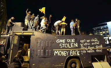 Unprecedented developments in SL were inevitable: Strategic affairs experts Protesters stand on a vandalised police water canon truck and shout slogans at the entrance to president's official residence in Colombo (Photo: AP/PTI)
