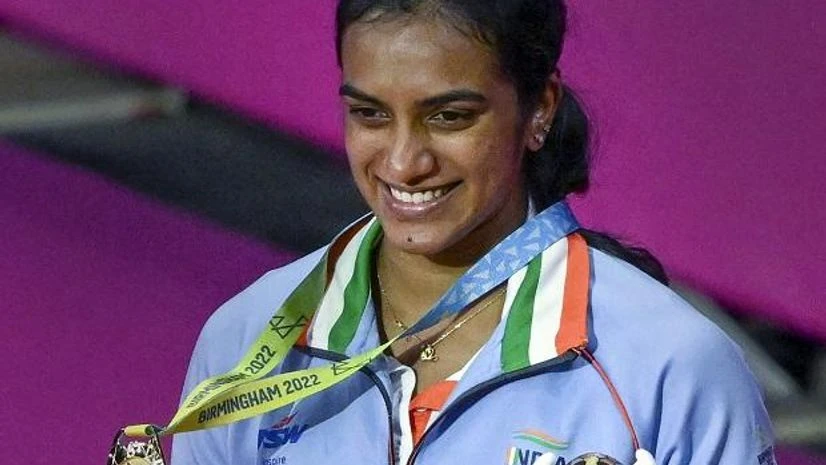 P V Sindhu, Commonwealth Games, CWG 2022 P V Sindhu poses for photos with her gold medal after winning the Womens Singles Final Badminton match against Canada's Michelle Li at the Commonwealth Games 2022 (CWG), in Birmingham (Photo: PTI)