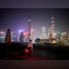 Shanghai skyline, The Bund A security guard keeps watch on a bridge at the Bund amid a heatwave warning, as Shanghai switches off lights along a popular waterfront to conserve energy in Shanghai (Photo: Reuters)