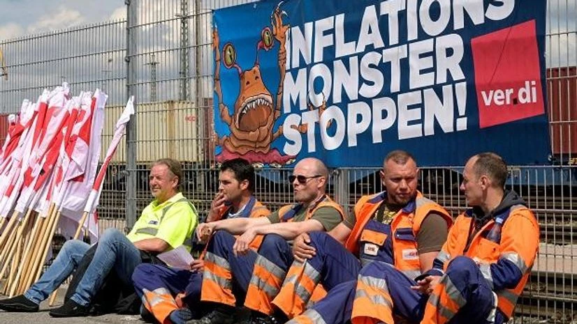 Inflation Workers sit in front of a banner reading 'Stop the Inflation Monster' at the Burchardkai Container Terminal as they go on strike for higher wages in the harbour in Hamburg (File photo: Reuters)