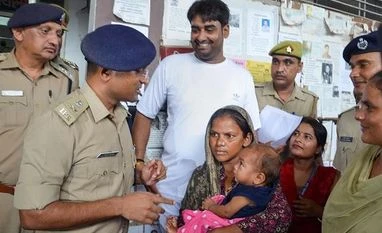 Police hands over the 7-month-old boy to his mother after he was recovered from Firozabad in a corporator's house, in Mathura Police hands over the 7-month-old boy to his mother after he was recovered from Firozabad in a corporator's house, in Mathura