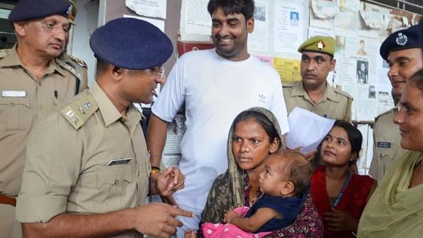 Police hands over the 7-month-old boy to his mother after he was recovered from Firozabad in a corporator's house, in Mathura Police hands over the 7-month-old boy to his mother after he was recovered from Firozabad in a corporator's house, in Mathura