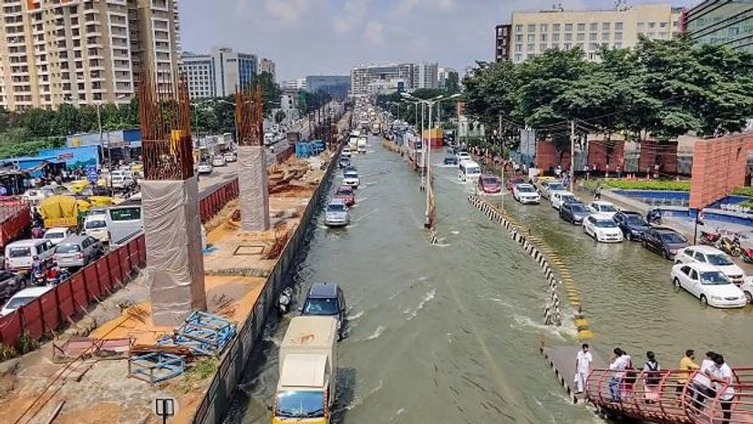Vehicles pass through the waterlogged Outer Ring Road at Bellandur in Bengaluru Vehicles pass through the waterlogged Outer Ring Road at Bellandur in Bengaluru