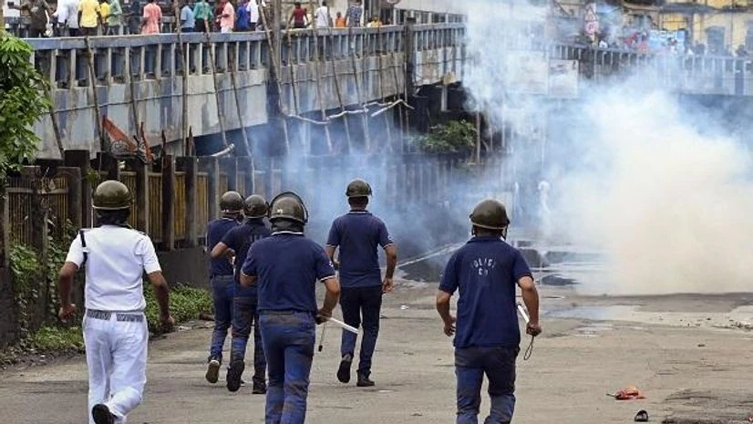 Security personnel use tear gas to disperse BJP supporters from the Howrah Bridge during their Nabanna Abhijan (March to Secretariat) to protest against alleged corrupt practices of TMC government, in Kolkata (Photo: PTI) Security personnel use tear gas to disperse BJP supporters from the Howrah Bridge during their Nabanna Abhijan (March to Secretariat) to protest against alleged corrupt practices of TMC government, in Kolkata (Photo: PTI)