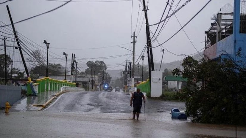 Hurricane Fiona A man wades through a flooded street after Hurricane Fiona affected the area in Yauco, Puerto Rico (Photo: Reuters)