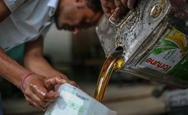 cooking oil Workers of Social Development For Communities Foundation, a raw material aggregator for the institute, collect used cooking oil at a restaurant in Dehradun. (Photo: Bloomberg)