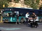 Jerusalem A police officer holds a dog next to a damaged bus following an explosion at a bus stop in Jerusalem November 23, 2022. REUTERS/Ronen Zvulun