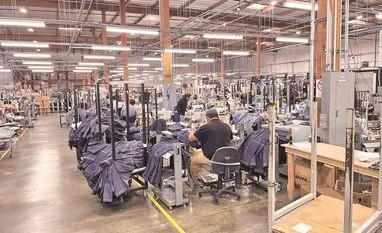 Factory, blue jeans People work at Saitex’s factory, which experiments with new robots to cut the cost of making blue jeans, in Los Angeles (Photo: Reuters)