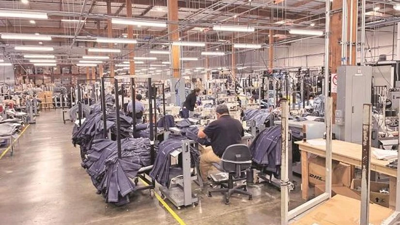 Factory, blue jeans People work at Saitex’s factory, which experiments with new robots to cut the cost of making blue jeans, in Los Angeles (Photo: Reuters)