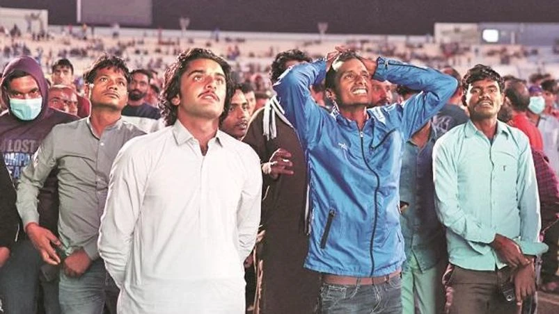 Migrant workers, Qatar Migrant workers watch a World Cup match in Doha (Photo: Reuters)