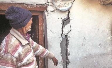 MoS Ajay Bhatt reaches Joshimath, holds discussions with officials Authorities were scheduled to demolish hotels and houses in Joshimath. Photo: PTI