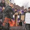 Ambulance workers keep a fire going to keep warm outside their Waterloo station, amid a strike due to a dispute with the government over pay. (Photo: Reuters)