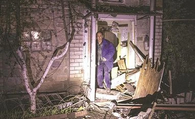 A local resident stands next to his house damaged by a Russian missile strike in Ukraine, on Sunday A local resident stands next to his house damaged by a Russian missile strike in Ukraine, on Sunday