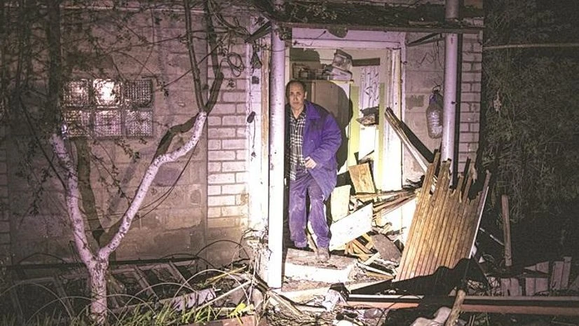 A local resident stands next to his house damaged by a Russian missile strike in Ukraine, on Sunday A local resident stands next to his house damaged by a Russian missile strike in Ukraine, on Sunday