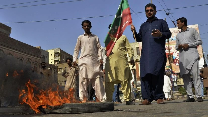 Supporters of Pakistan's former Prime Minister Imran Khan burn tires during a protest to condemn the arrest of their leader, Hyderabad, Pakistan, Tuesday, May 9, 2023. Pakistan's anti-graft agents on Tuesday arrested former Prime Minister Khan as he Supporters of Pakistan's former Prime Minister Imran Khan burn tires during a protest to condemn the arrest of their leader, Hyderabad, Pakistan, Tuesday, May 9, 2023. Pakistan's anti-graft agents on Tuesday arrested former Prime Minister Khan as he