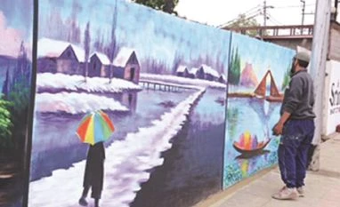 An artist works on a wall mural in Srinagar as city gets ready to welcome G20 delegates. Photo: Firdous Hassan An artist works on a wall mural in Srinagar as city gets ready to welcome G20 delegates. Photo: Firdous Hassan