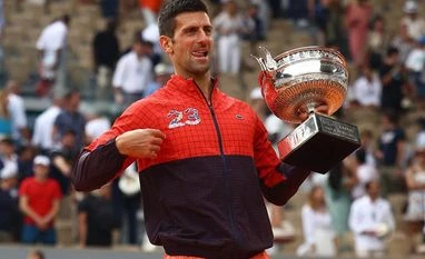 US Open: Novak Djokovic comes back from two sets down to beat Laslo Djere Novak Djokovic poses with the trophy after winning the French Open and his 23rd Grand Slam. Photo: Reuters