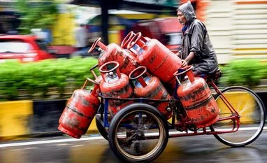 Aadhaar-based eKYC for LPG users by OMCs: Here's all you need to know Delivery man transports LPG cylinders on a cart