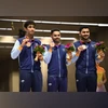 Asian Games - Hangzhou 2022 - Shooting - Fuyang Yinhu Sports Centre, Hangzhou, China - September 25, 2023 Bronze medallist India's Adarsh Singh, Anish and Vijayveer Sidhu celebrate on the podium after the men's team Asian Games - Hangzhou 2022 - Shooting - Fuyang Yinhu Sports Centre, Hangzhou, China - September 25, 2023 Bronze medallist India's Adarsh Singh, Anish and Vijayveer Sidhu celebrate on the podium after the men's team