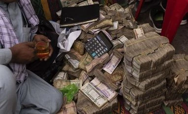 Bundles of afghani banknotes at the Sarai Shahzada exchange market. Bundles of afghani banknotes at the Sarai Shahzada exchange market.