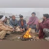 People sit around a bonfire amid fog on a cold winter morning at Sector 9, in Gurugram, Thursday, Nov. 30, 2023. (PTI Photo) People sit around a bonfire amid fog on a cold winter morning at Sector 9, in Gurugram, Thursday, Nov. 30, 2023. (PTI Photo)