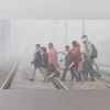 Commuters cross a railway track amid fog on a cold winter morning, in Gurugram, Thursday, Nov. 30, 2023. (PTI Photo) Commuters cross a railway track amid fog on a cold winter morning, in Gurugram, Thursday, Nov. 30, 2023. (PTI Photo)