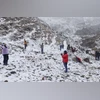 Tourists click photographs at snow-covered Koksar after fresh snowfall, in Lahaul & Spiti district. (PTI Photo) Tourists click photographs at snow-covered Koksar after fresh snowfall, in Lahaul & Spiti district. (PTI Photo)