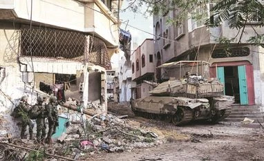 India votes in favour of UNGA draft resolution demanding ceasefire in Gaza Israeli soldiers operate with a tank at the Shajaiya district of Gaza city