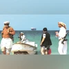 Will target only Israel-linked vessels after Gaza ceasefire: Yemen's Houthi Armed men at a beach as a commercial ship, seized by Yemen's Houthis last month, is anchored off the coast