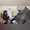 A polling officer marks the finger of a woman (R) after casting her ballot at a polling station during national elections in Islamabad on February 8, 2024. — AFP A polling officer marks the finger of a woman (R) after casting her ballot at a polling station during national elections in Islamabad on February 8, 2024. — AFP