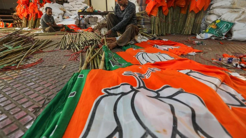 Workers arrange BJP flags ahead of the Lok Sabha elections, at the party office in Jammu, Tuesday, April 2, 2024. (PTI Photo) Workers arrange BJP flags ahead of the Lok Sabha elections, at the party office in Jammu, Tuesday, April 2, 2024. (PTI Photo)