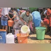 People collect free drinking water from a tanker due to the ongoing water crisis in Bengaluru. The city's population has tripled since 1990, and it is estimated to require as much as 2,632 MLD of freshwater — half of this comes from the Kaveri and th
