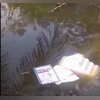 West Bengal violence, Lok Sabha elections Visual of an EVM machine thrown into a pond by an enraged mob in West Bengal. (PTI)