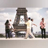 People walk at the Trocadero square as the Olympic rings are displayed on the Eiffel Tower, ahead of the Paris 2024 Olympics | Photo: Reuters People walk at the Trocadero square as the Olympic rings are displayed on the Eiffel Tower, ahead of the Paris 2024 Olympics | Photo: Reuters