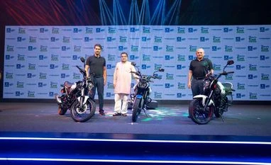 Bajaj Auto's CNG bike a bold move; customer adoption a concern: Analysts Union Minister for Road Transport & Highways Nitin Gadkari; Rajiv Baja, Managing Director, Bajaj auto Ltd; Rakesh Sharma, Executive Director, Bajaj Auto Ltd